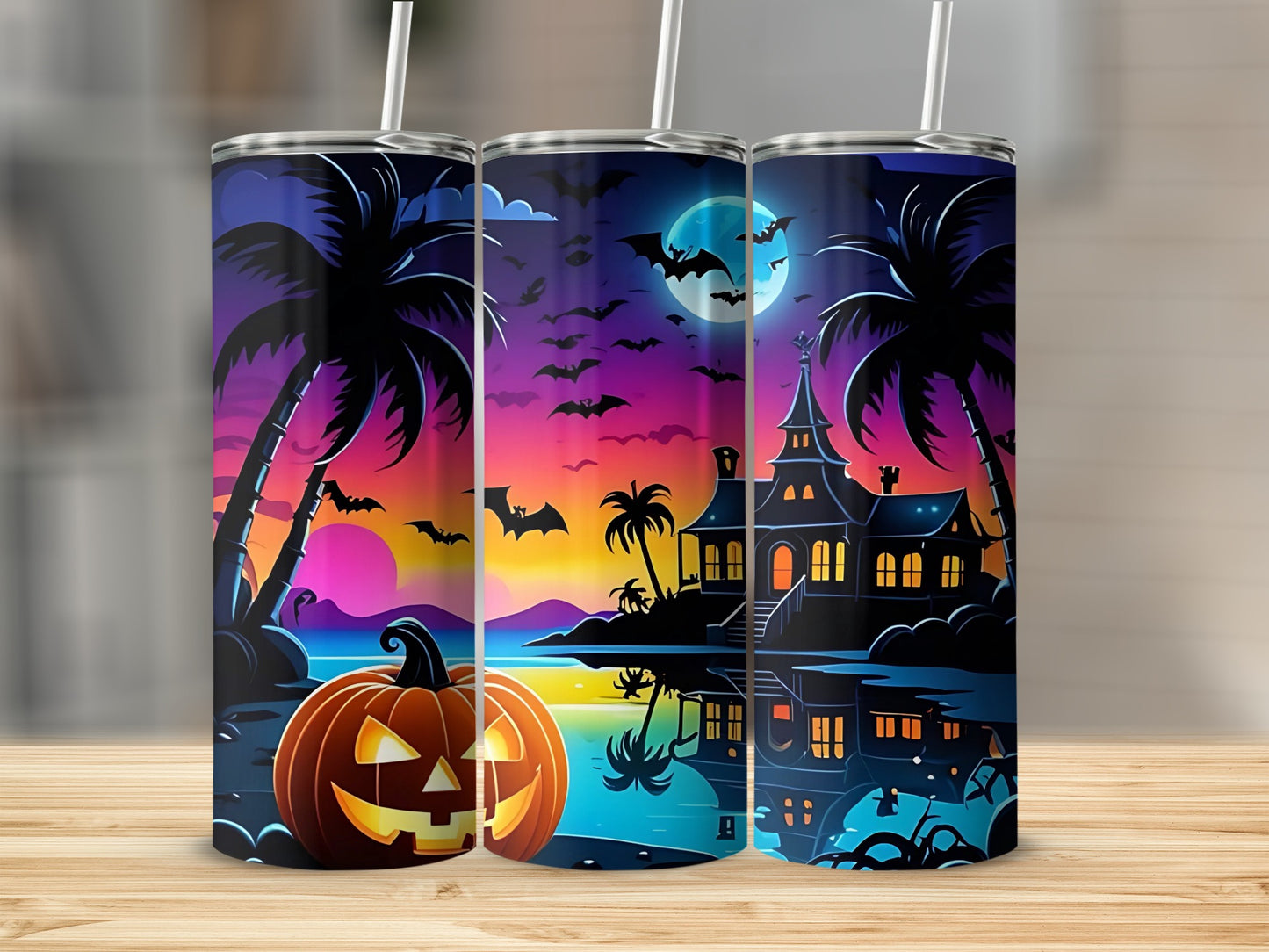 Halloween themed tumblers with haunted house, bats, pumpkin, and palm trees at sunset.