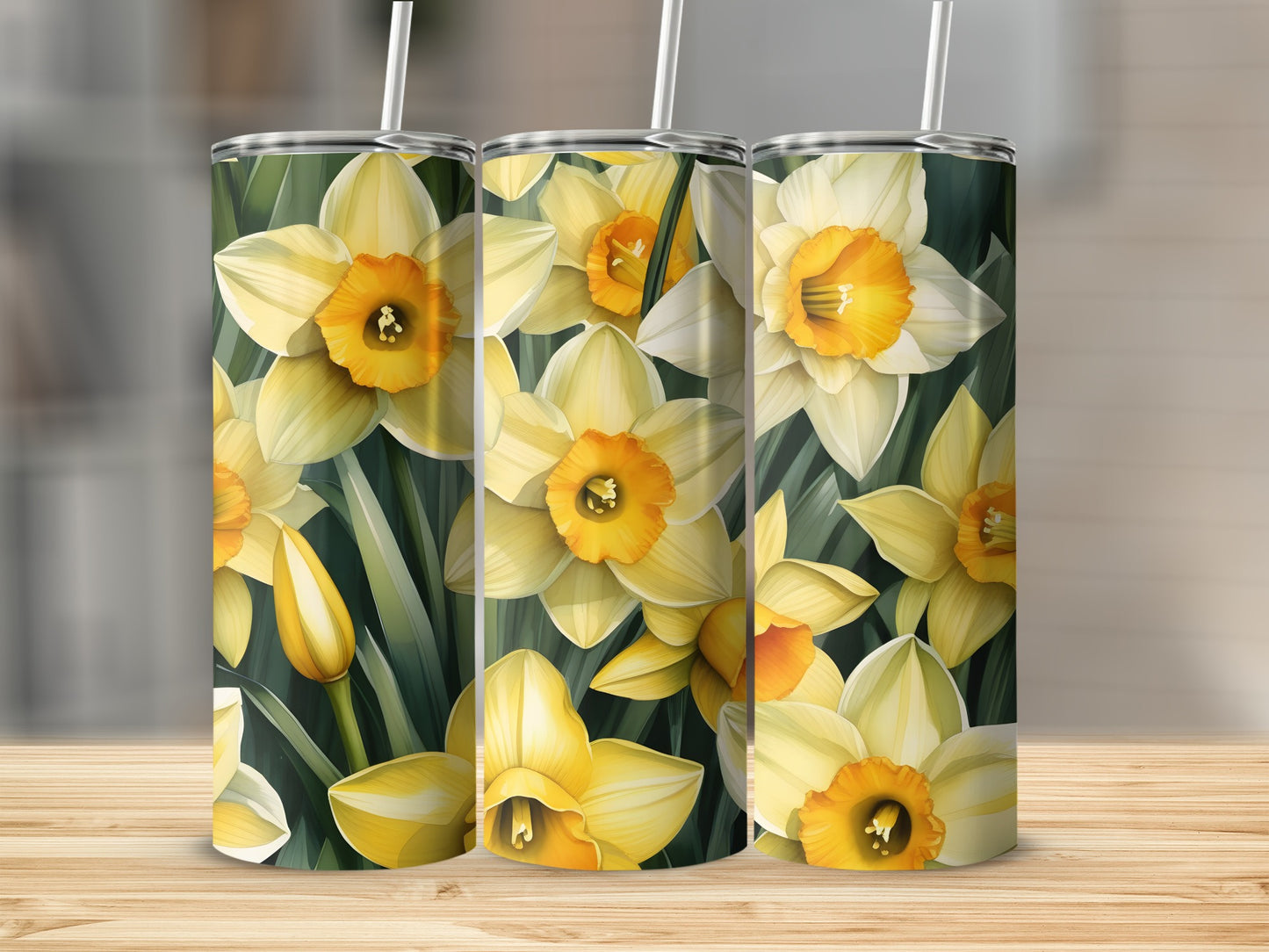 Three tumblers with a yellow and white daffodil floral pattern.