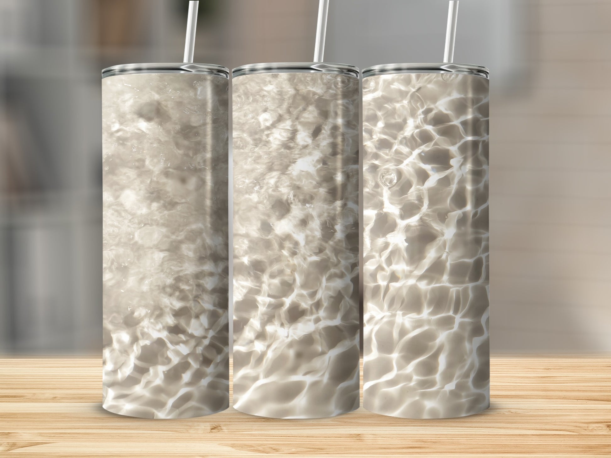 Three tumblers with a water ripple design on a wooden surface.