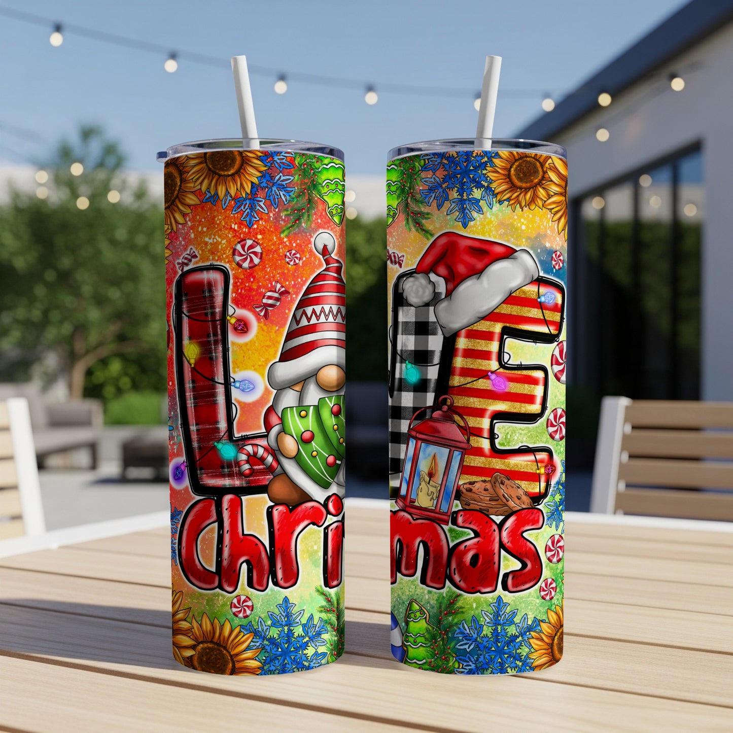 Two tumblers with Christmas gnome and "LOVE" lettering on a patio table.