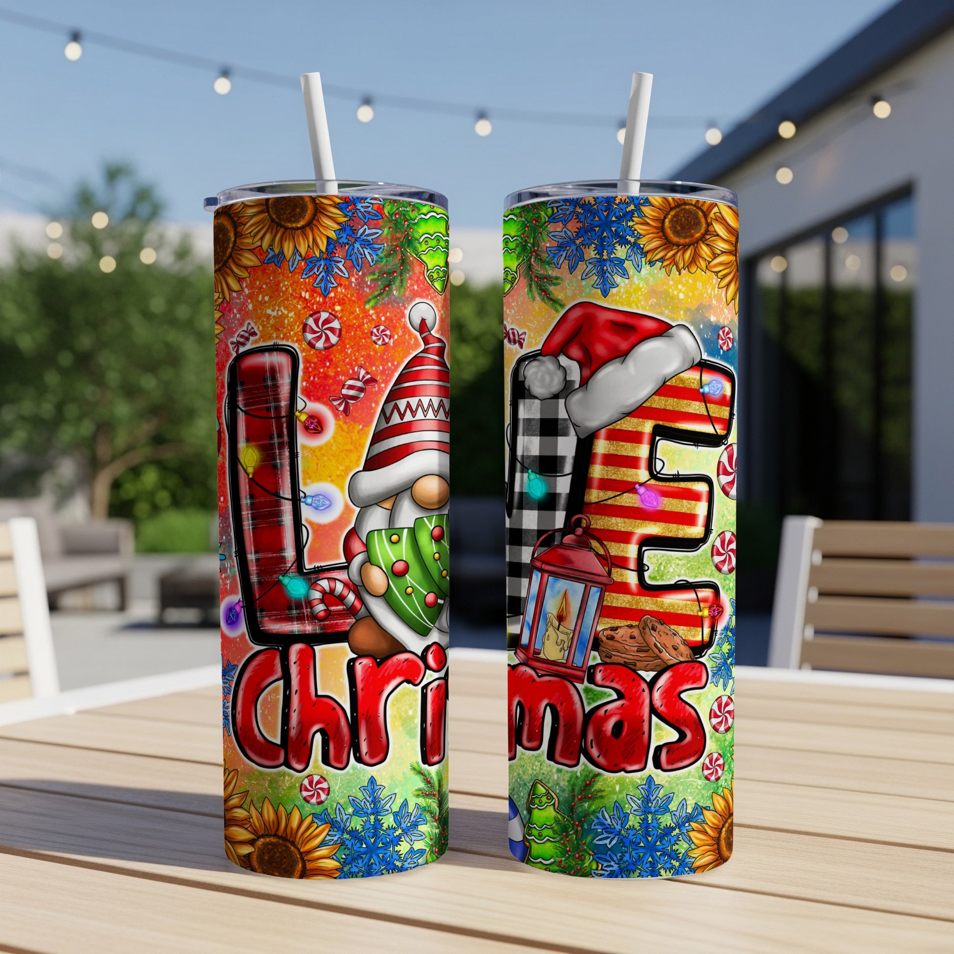 Two tumblers with Christmas gnome and "LOVE" lettering on a patio table.
