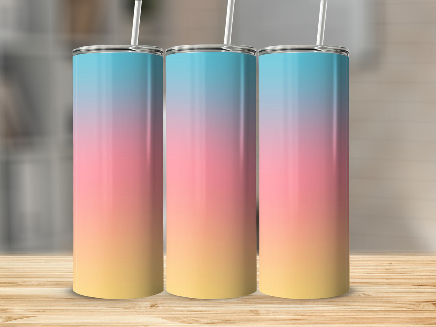 Three tall, slender tumblers with a pink, blue, and yellow ombre gradient.