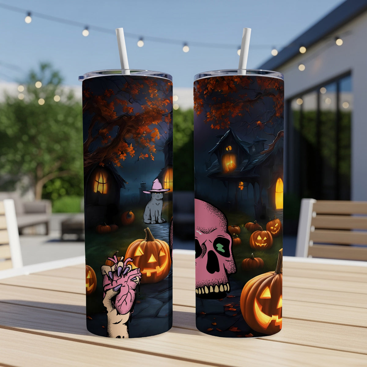 Two Halloween-themed tumblers with spooky house, cat, pumpkins, and anatomical heart designs.