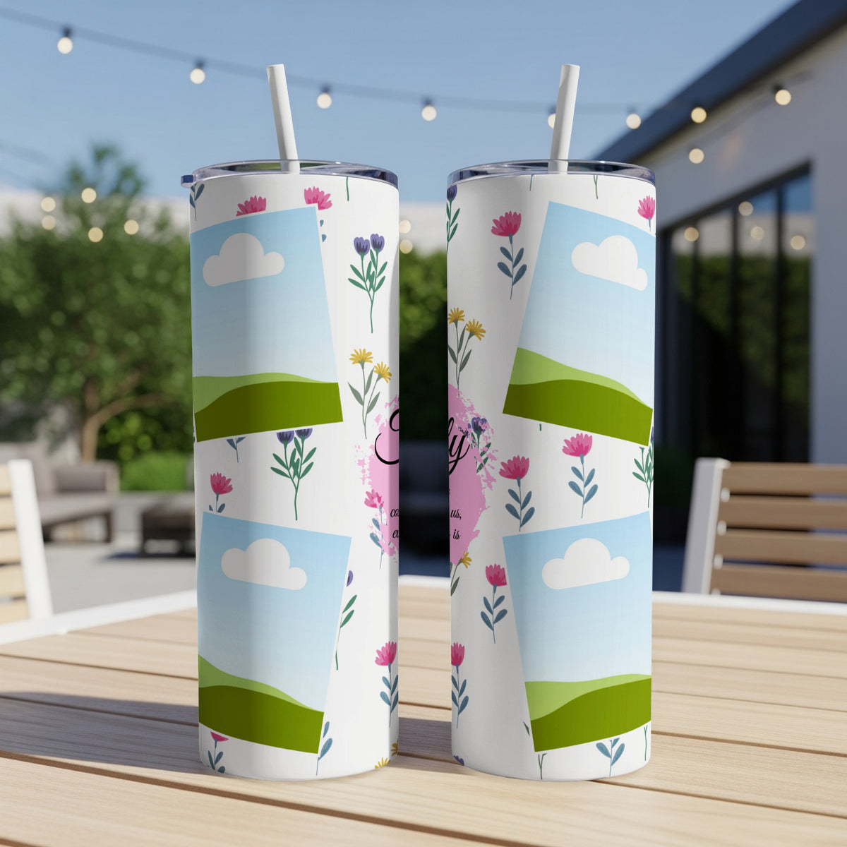 Floral tumbler with photo frames and text, featuring rolling hills and clouds.
