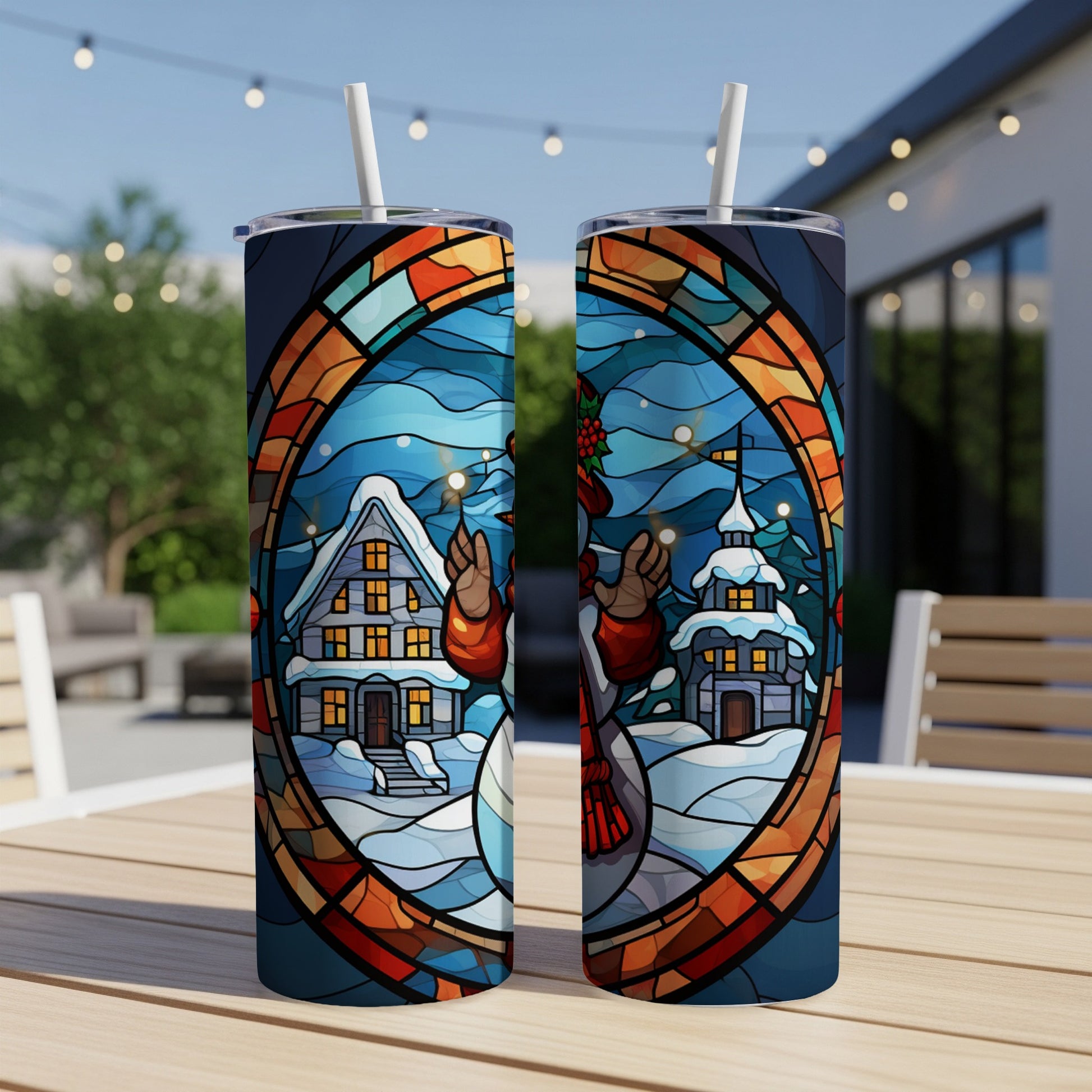 Two tumblers featuring stained glass art of a snowman and winter village.