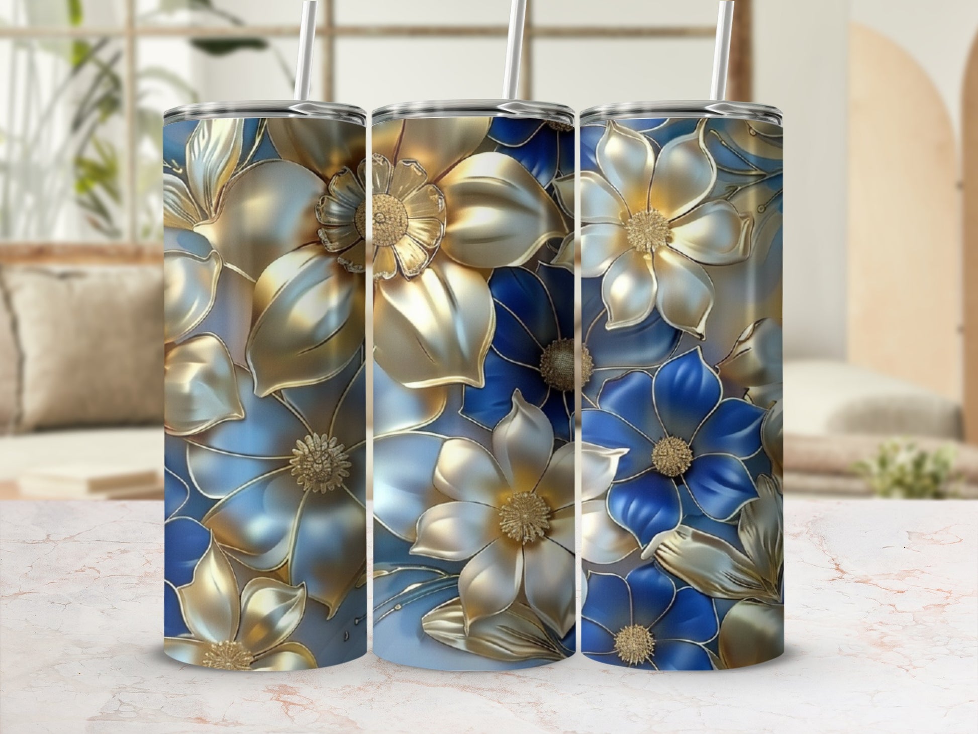 Three floral tumblers with blue and gold flower designs.