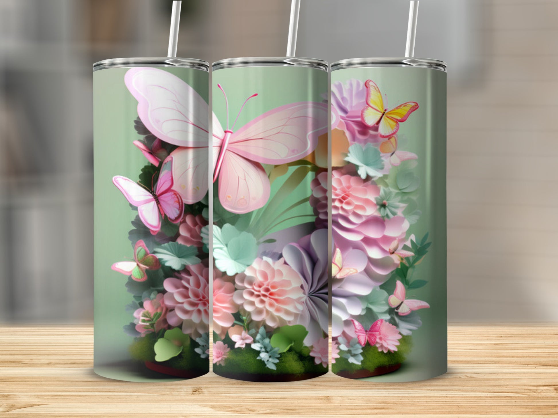 Three tumblers with pink butterflies and flowers on a green background.