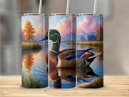 Mallard duck on water with autumn trees and mountains.