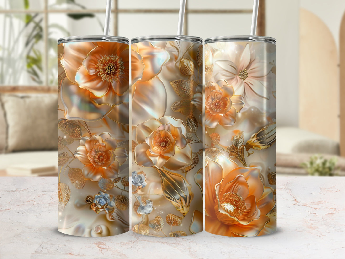 Triptych of tumblers with ornate gold floral designs on a marble surface.