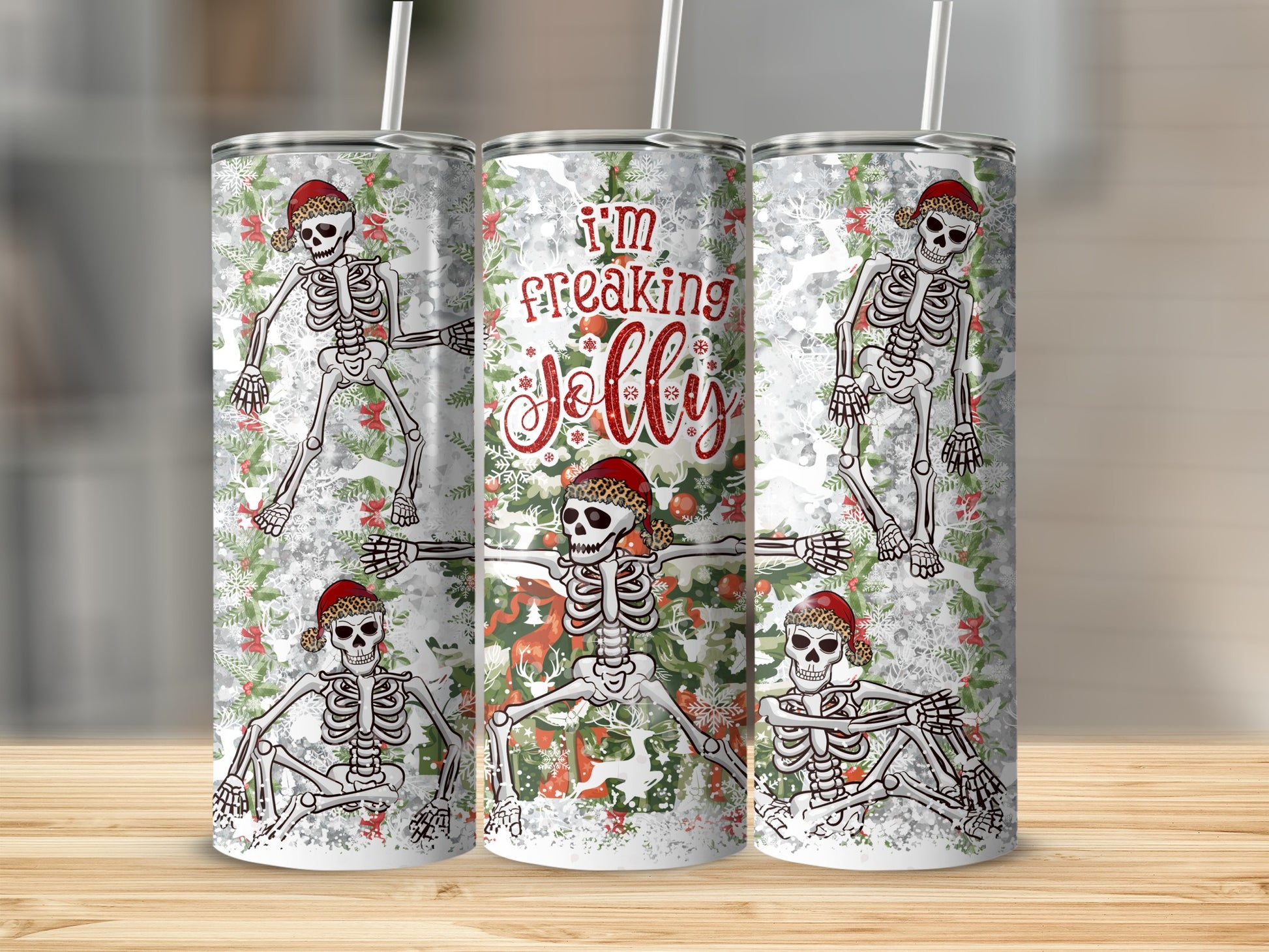 Three tumblers with skeletons, holly, and "I'm Freaking Jolly" text.