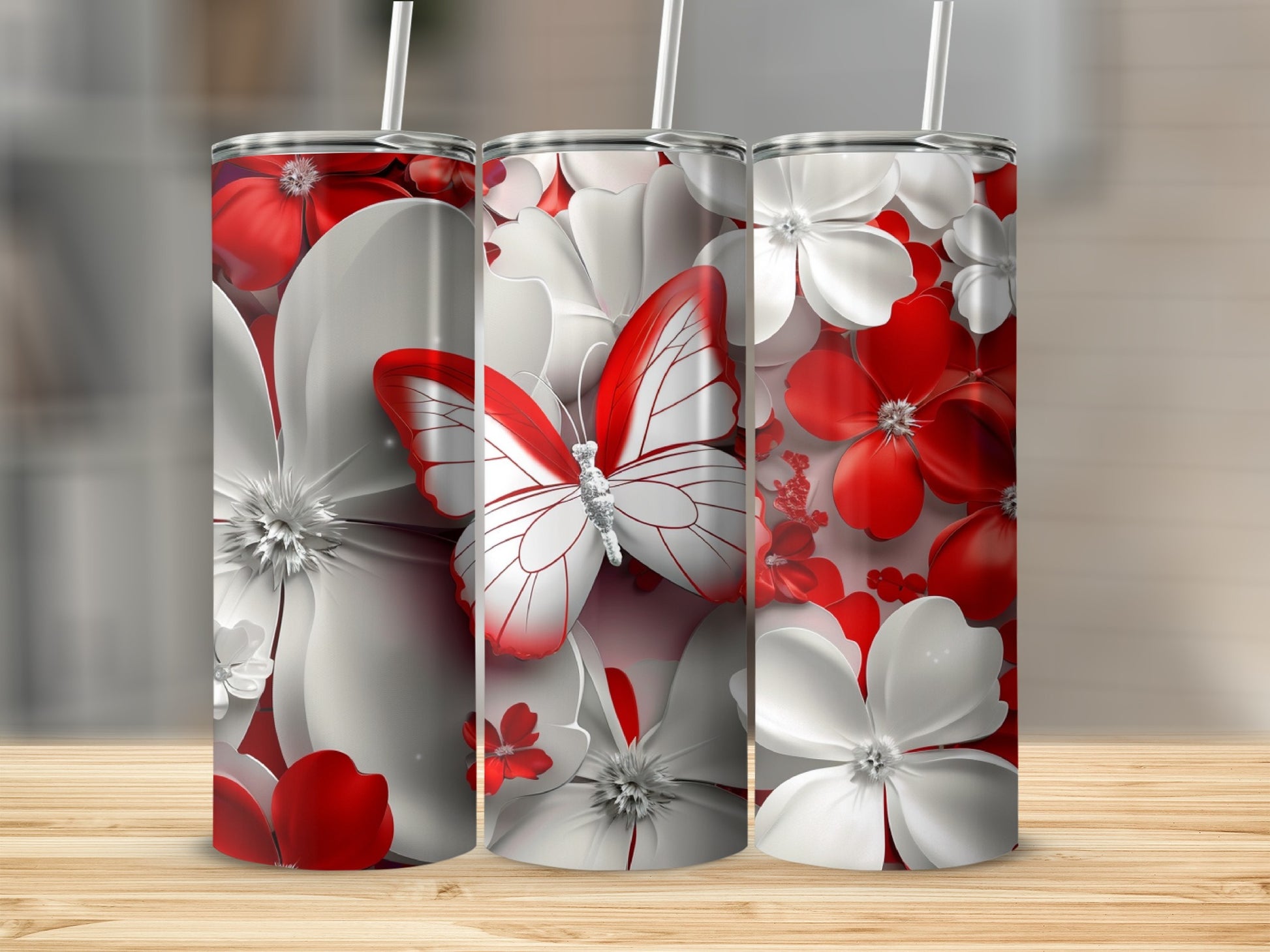 Three tumblers with red and white flowers and a butterfly.