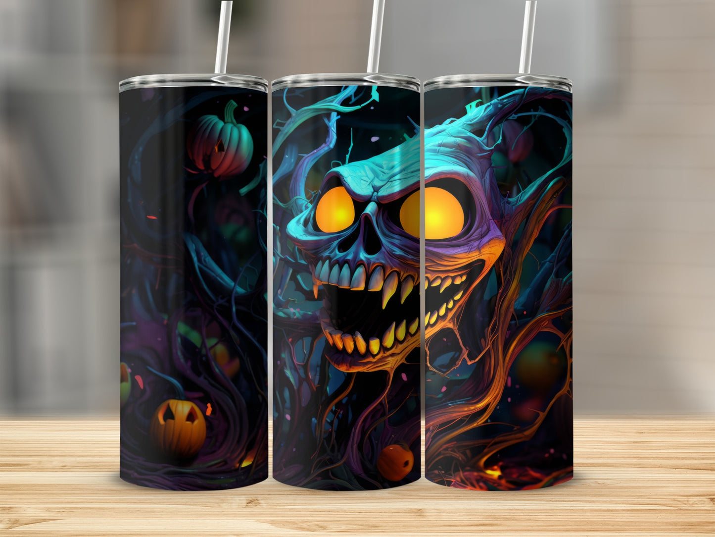 Three tumblers with a dark, abstract Halloween design featuring a monstrous skull and pumpkins.