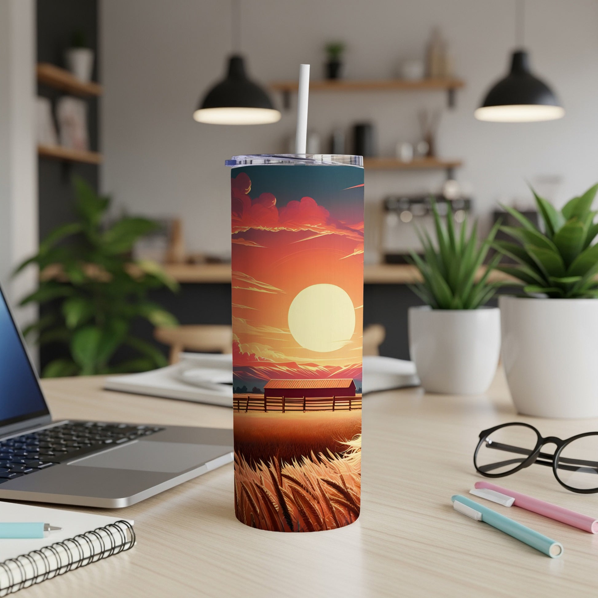 Tall tumbler with a sunset farm scene and a straw.