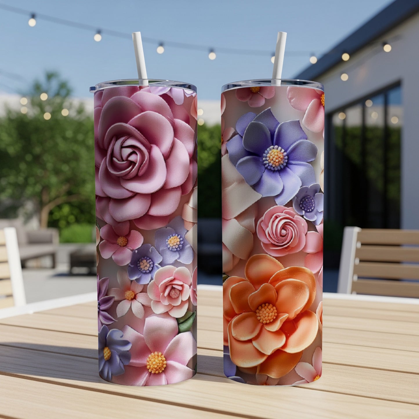 Two tall tumblers with floral designs sit on a table.