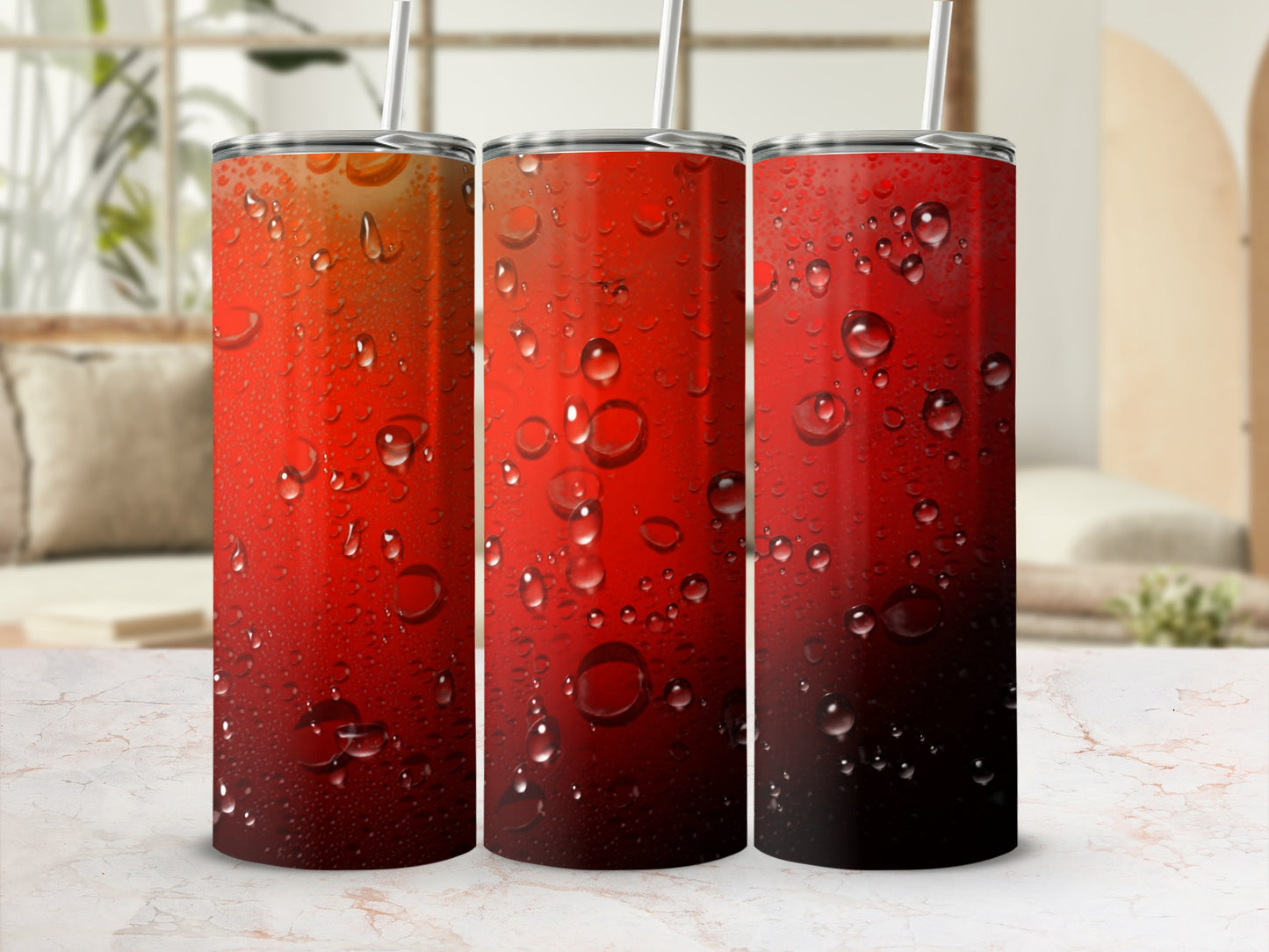 Three red gradient tumblers with water condensation and straws.
