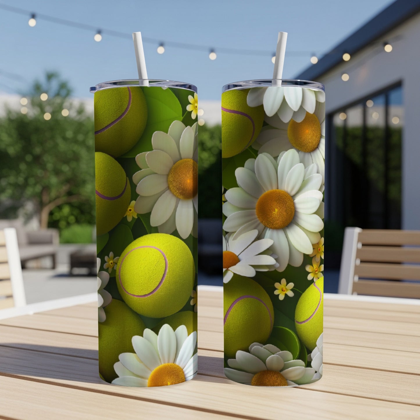 Tennis balls and daisies pattern on two tumblers on an outdoor table.