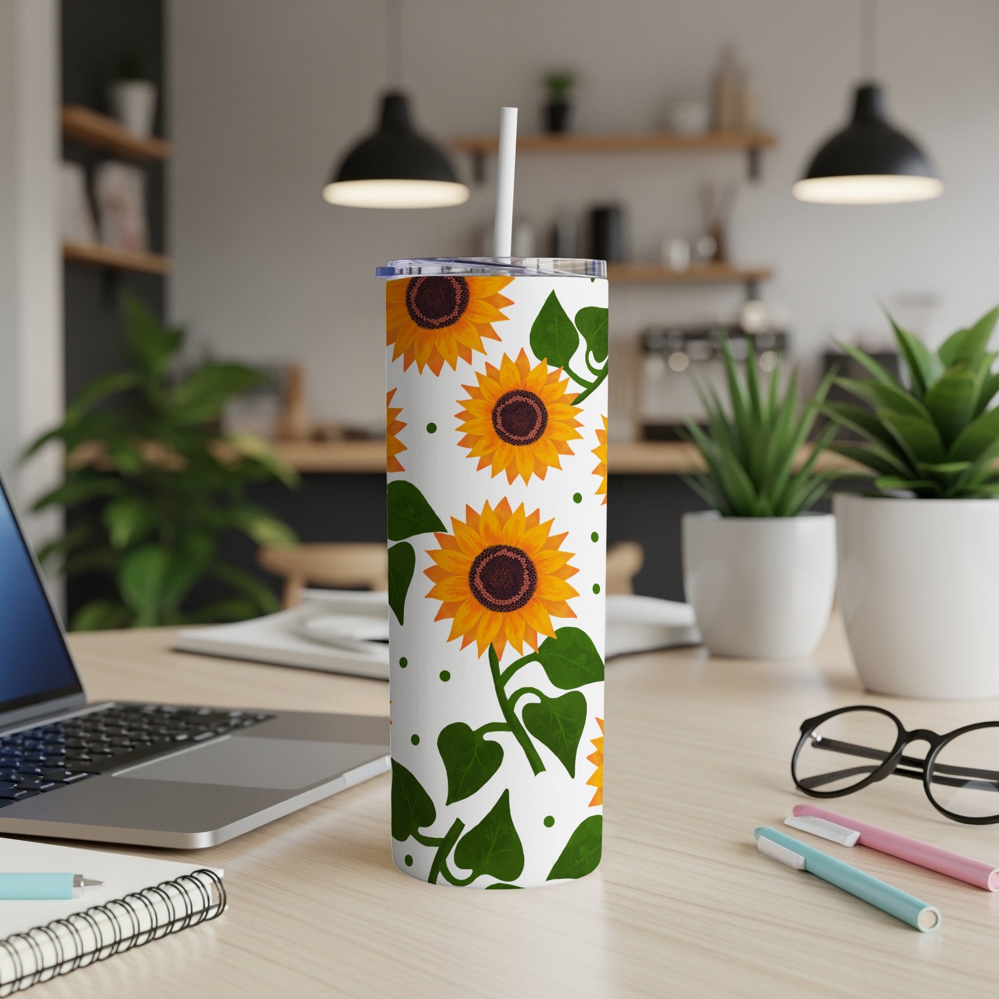 White tumbler with a repeating sunflower and green leaf pattern.