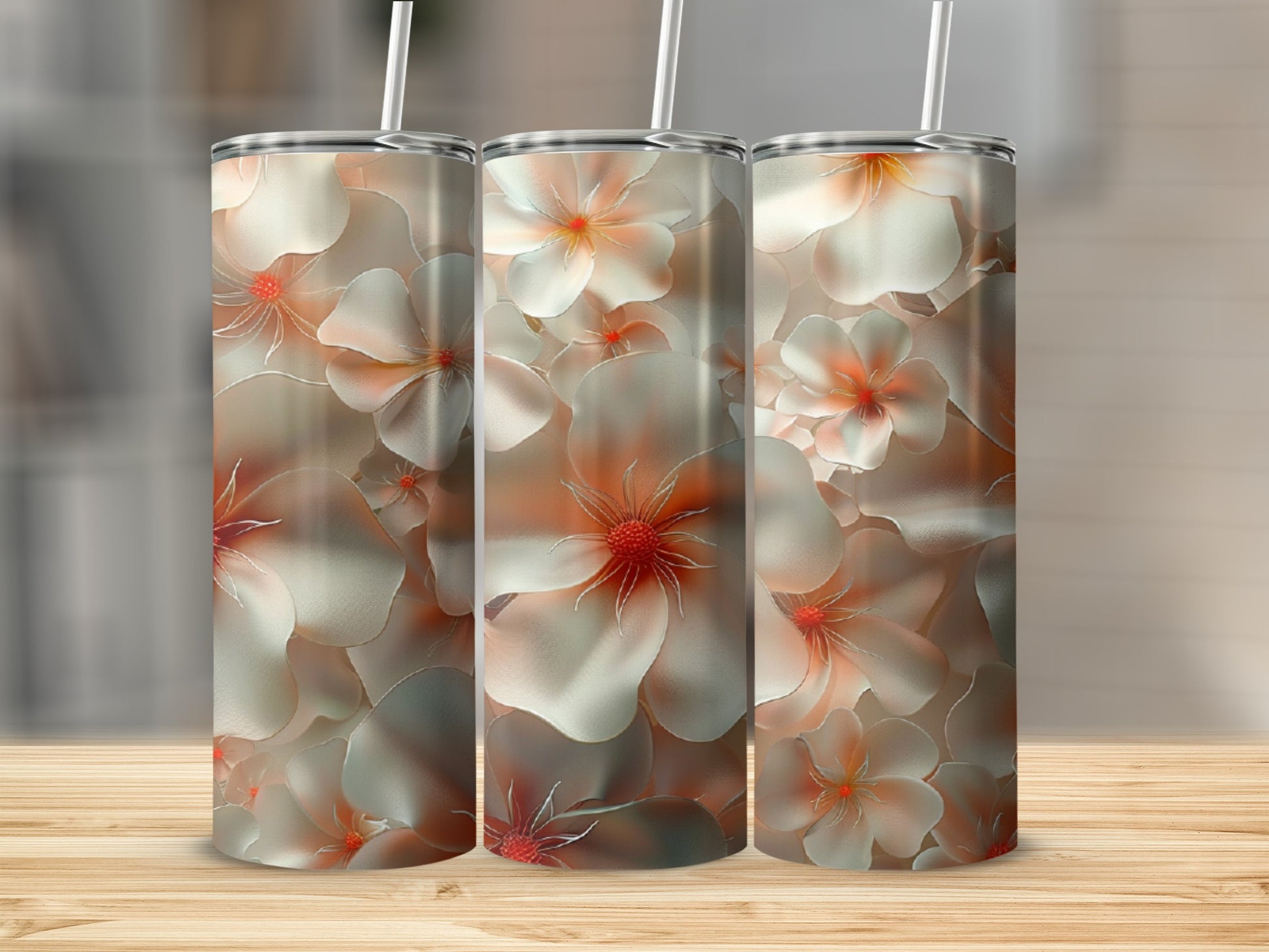 Three tumblers with a floral design featuring white and coral flowers.