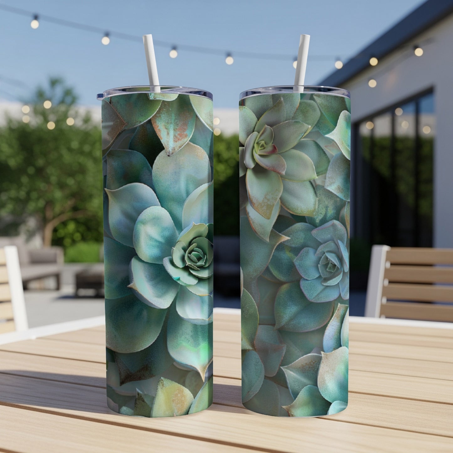 Two tumblers with a close-up succulent plant pattern on a patio table.