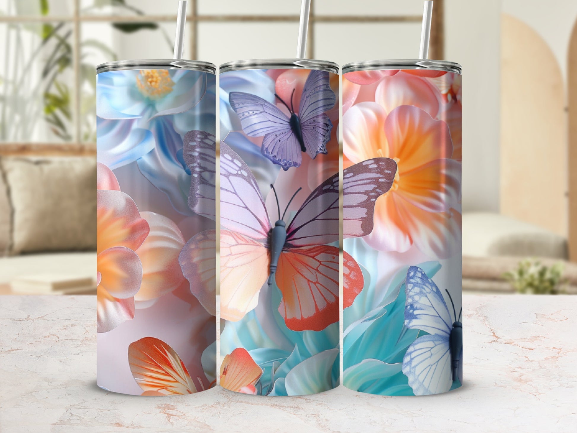 Three tumblers with colorful floral and butterfly designs, displayed side-by-side.