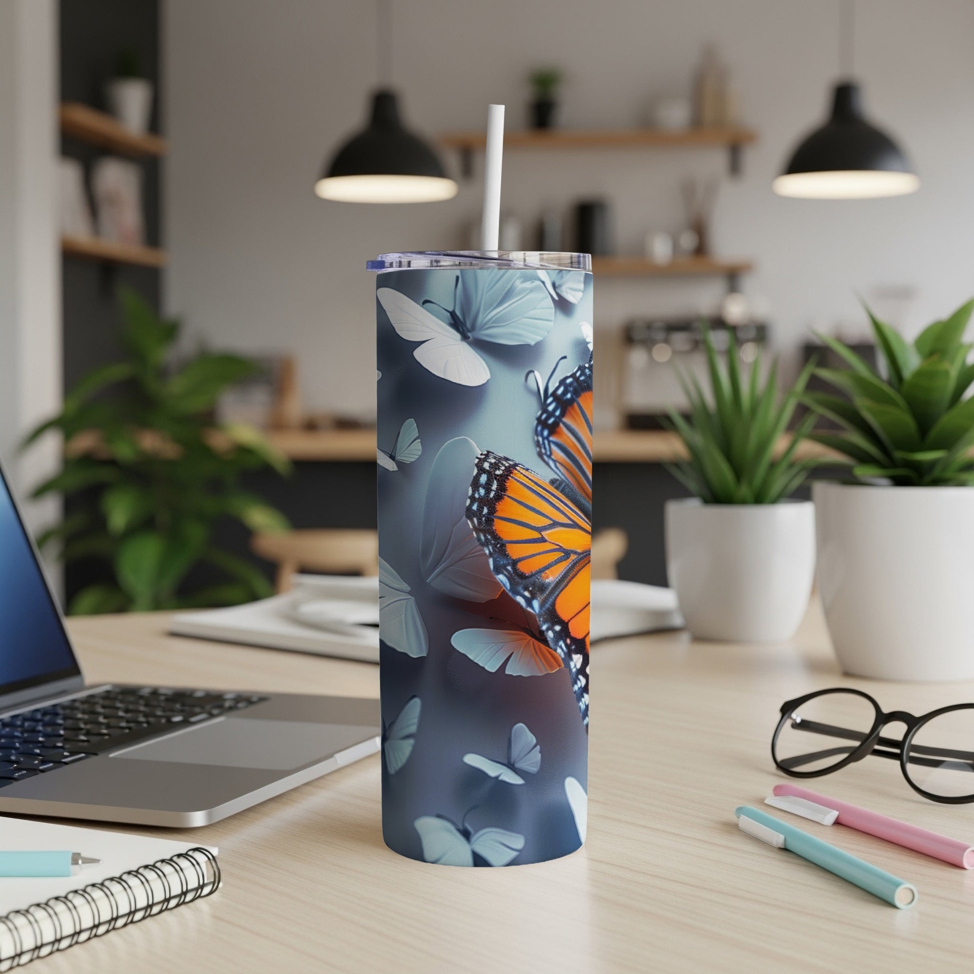 Monarch butterflies on a blue gradient tumbler with a straw.