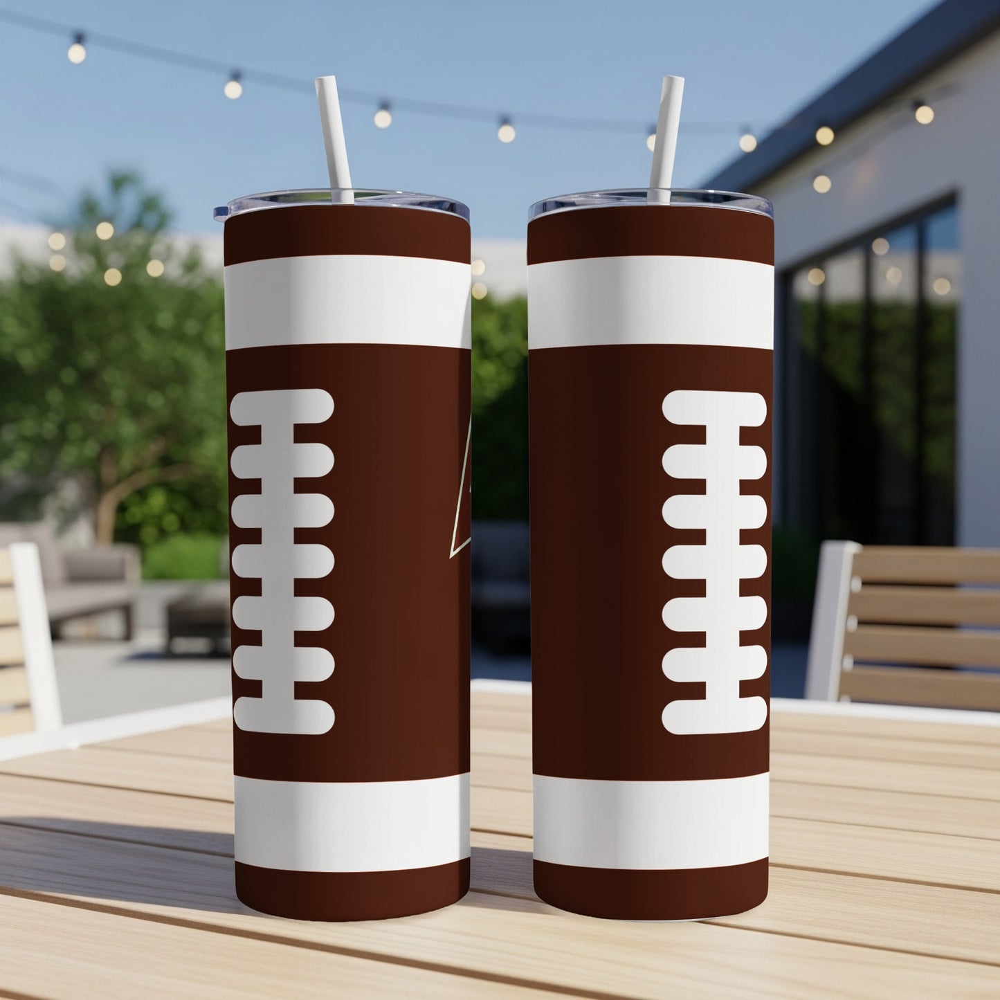 Two tall, brown tumblers with white football laces design.