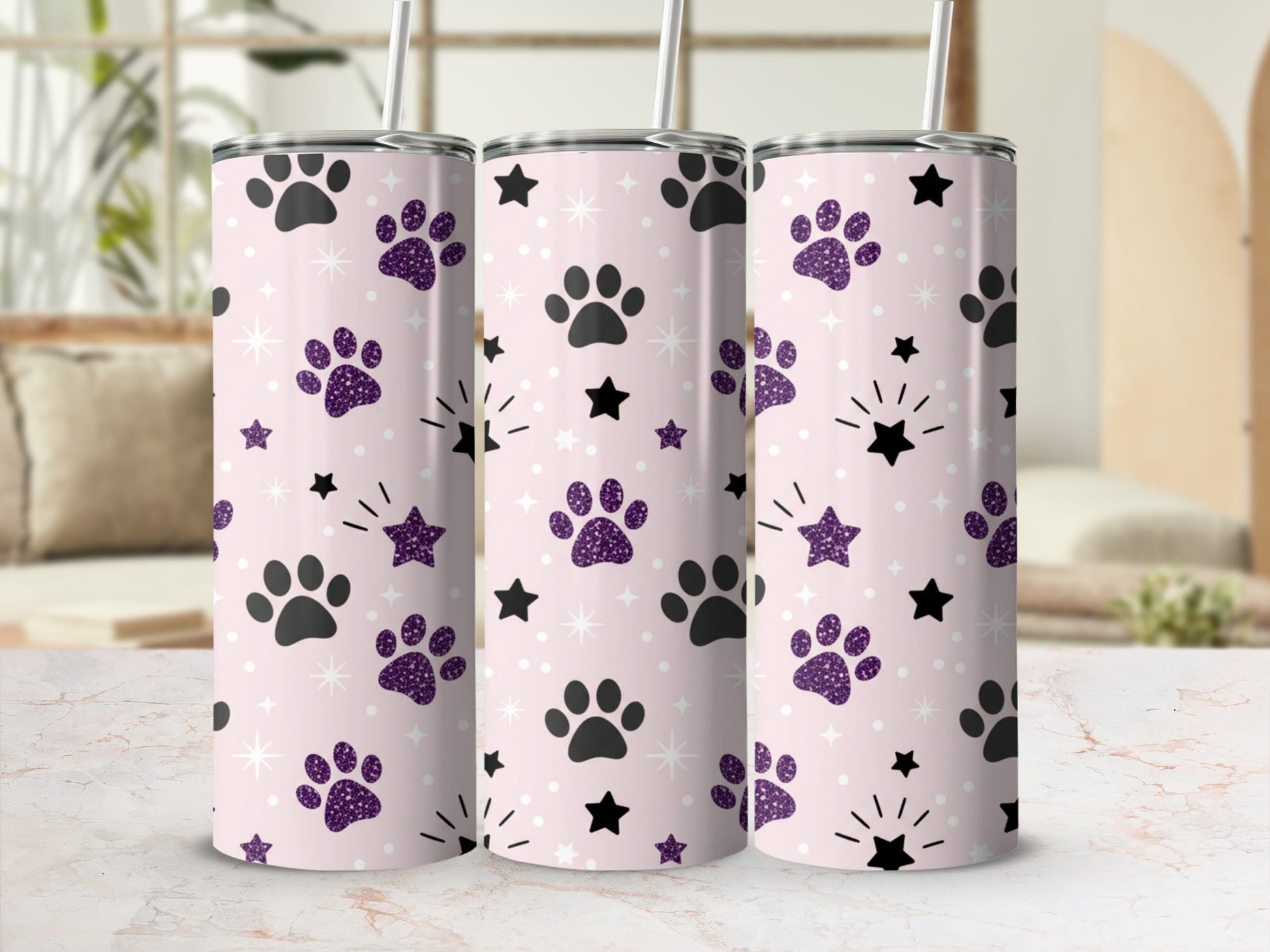 Pink tumbler with purple paw prints and black stars design.