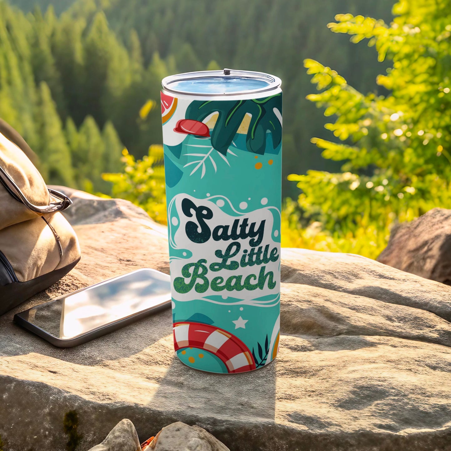 Tumbler with "Salty Little Beach" text and tropical graphics on a rock.