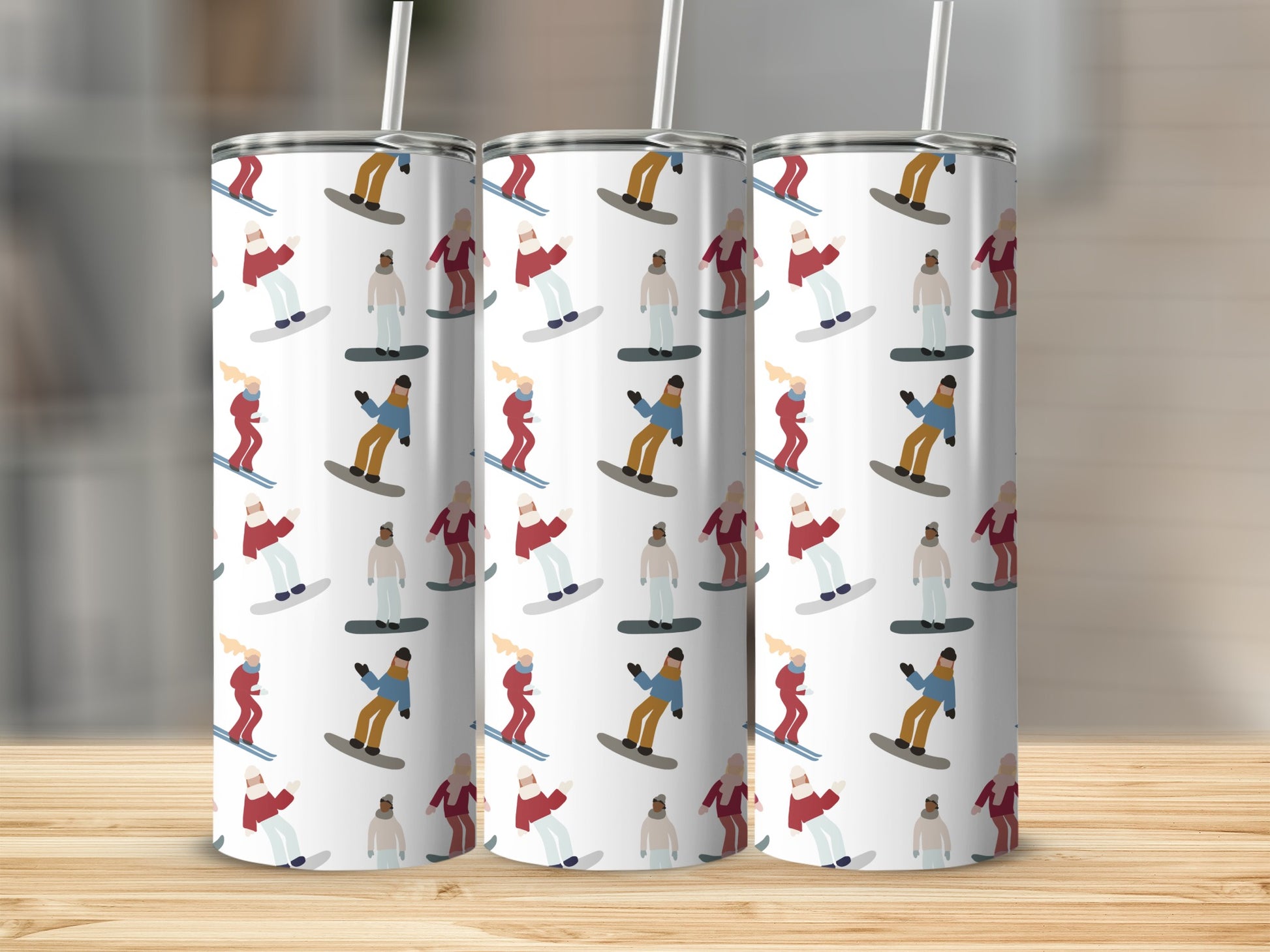 Three tumblers with a repeating pattern of skiers and snowboarders.