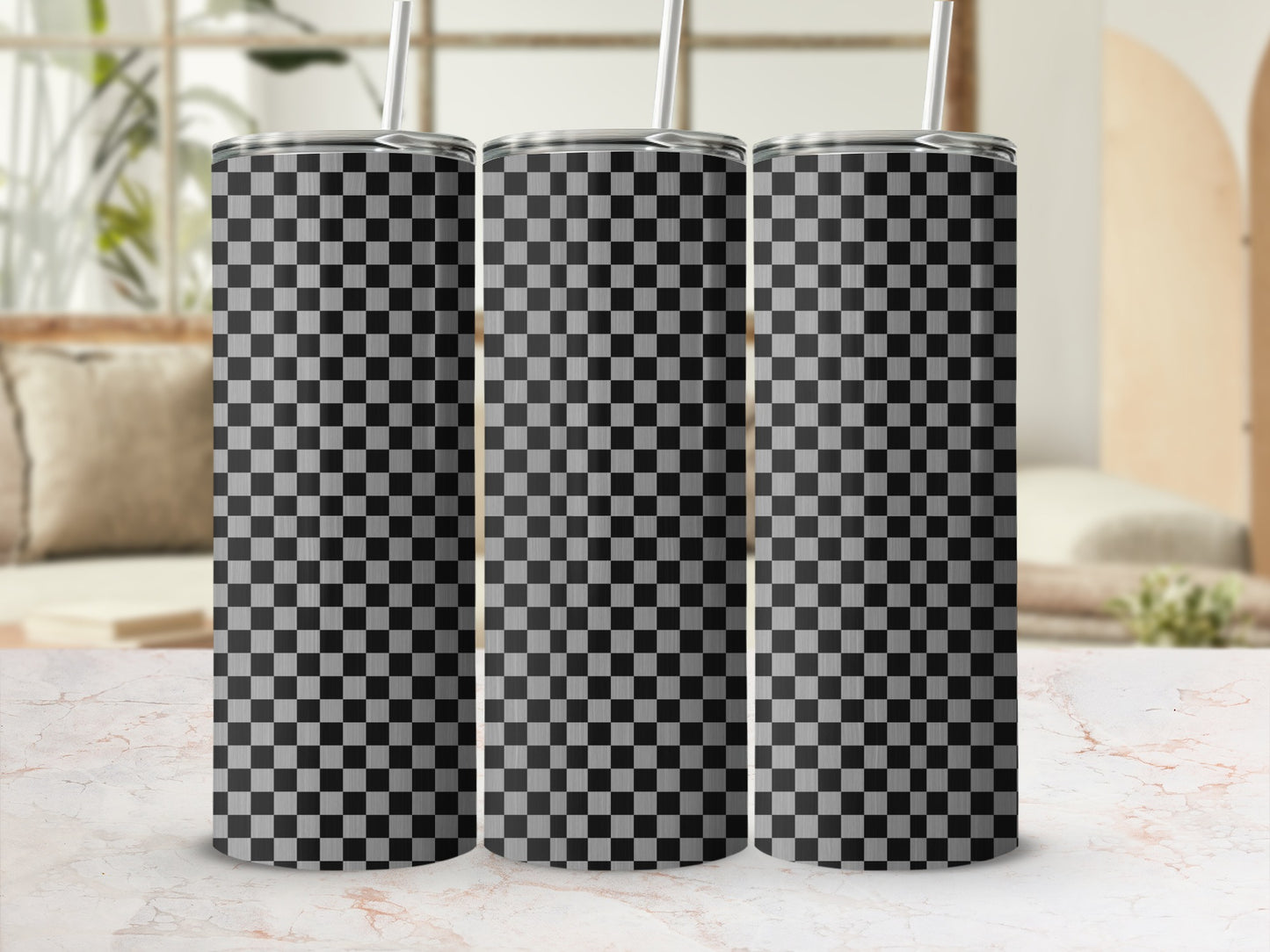 Three tumblers with a black and white checkered pattern, displayed on a marble surface.