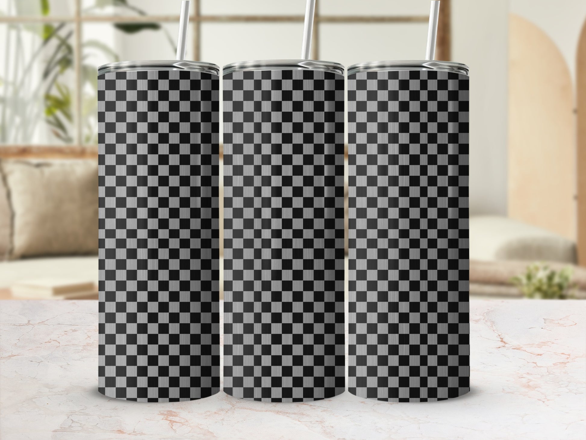Three tumblers with a black and white checkered pattern, displayed on a marble surface.