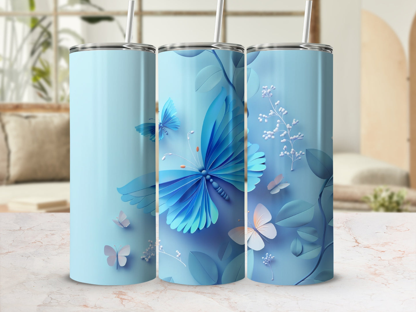 Three light blue tumblers with blue and white butterflies and floral designs.