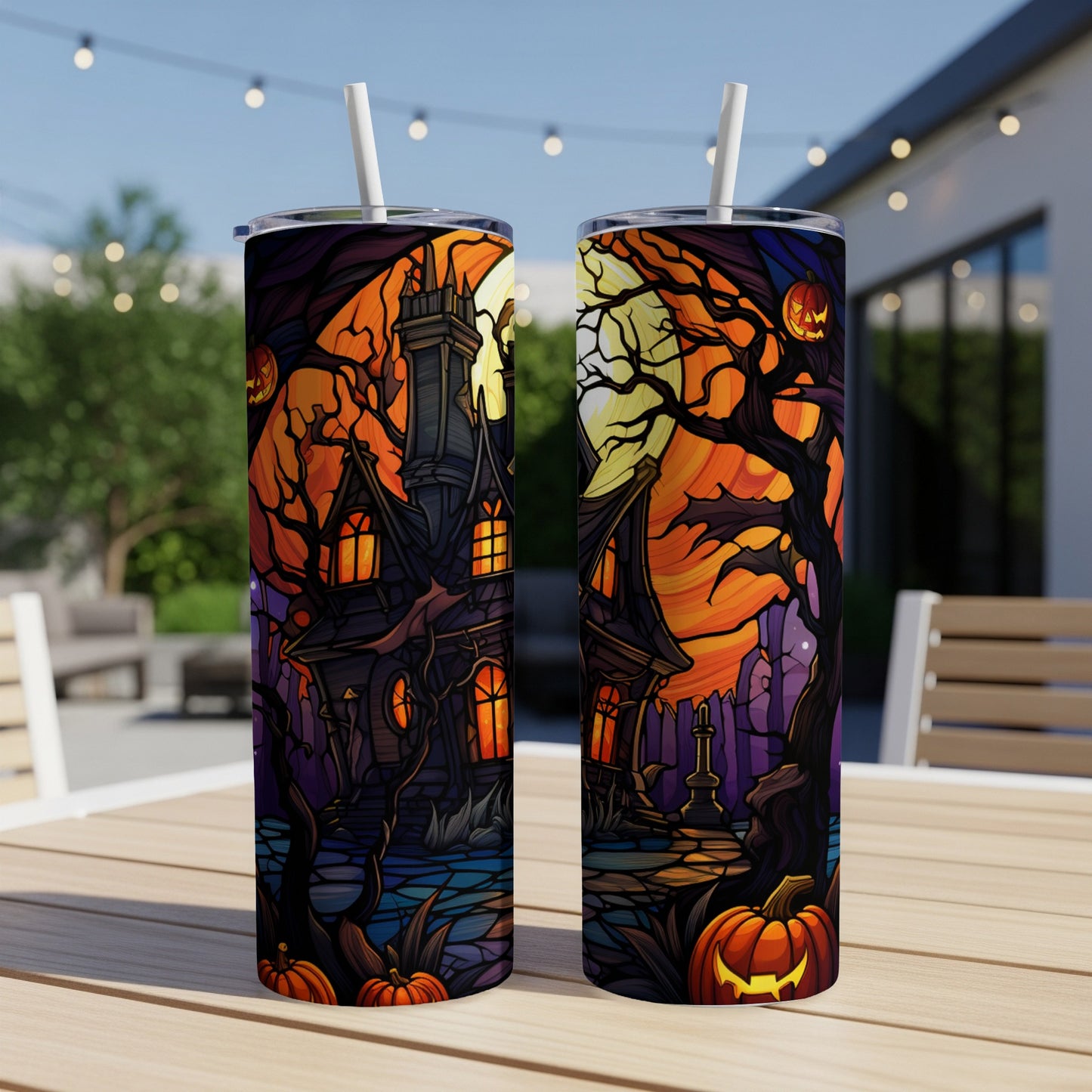 Two tumblers with a spooky haunted house and pumpkin Halloween design.