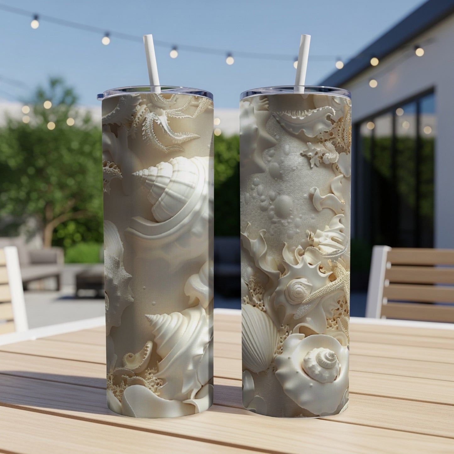 Two white tumblers with seashell and starfish embossed patterns.