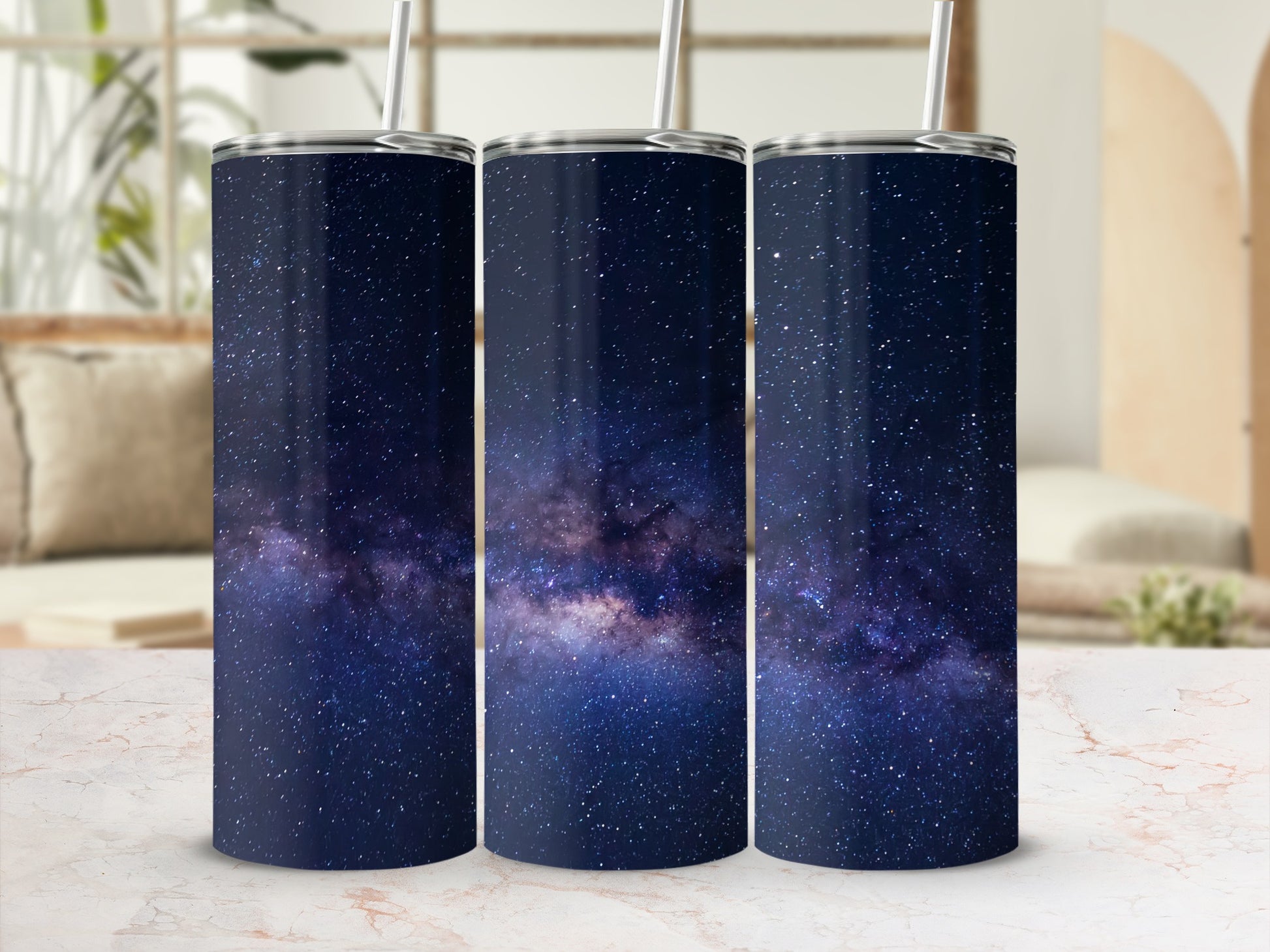 Three tumblers with a dark blue galaxy and star pattern.
