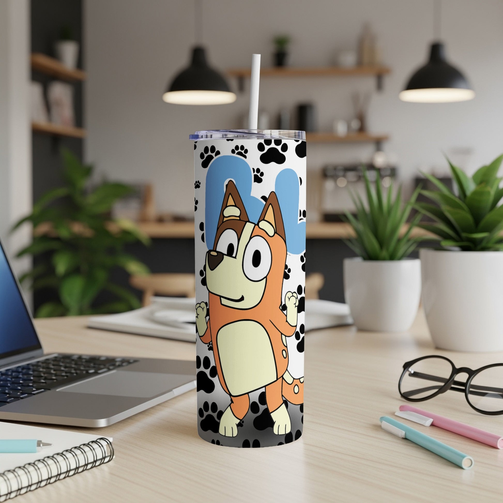 Bluey cartoon dog character on a white tumbler with paw print pattern.