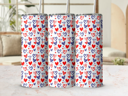 Three tumblers with a red and blue heart pattern and straws.