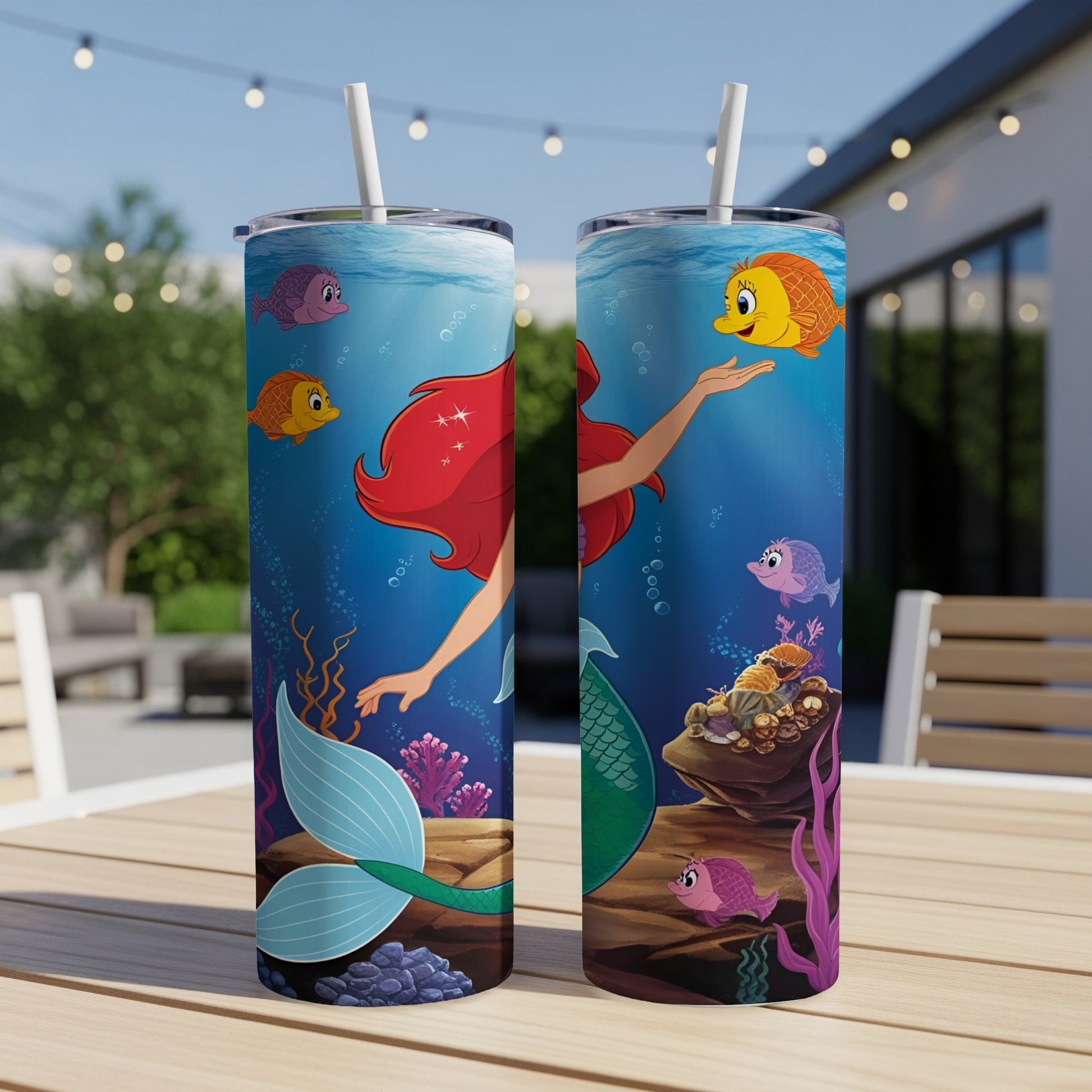 The Little Mermaid Ariel and Flounder swim with colorful fish underwater.