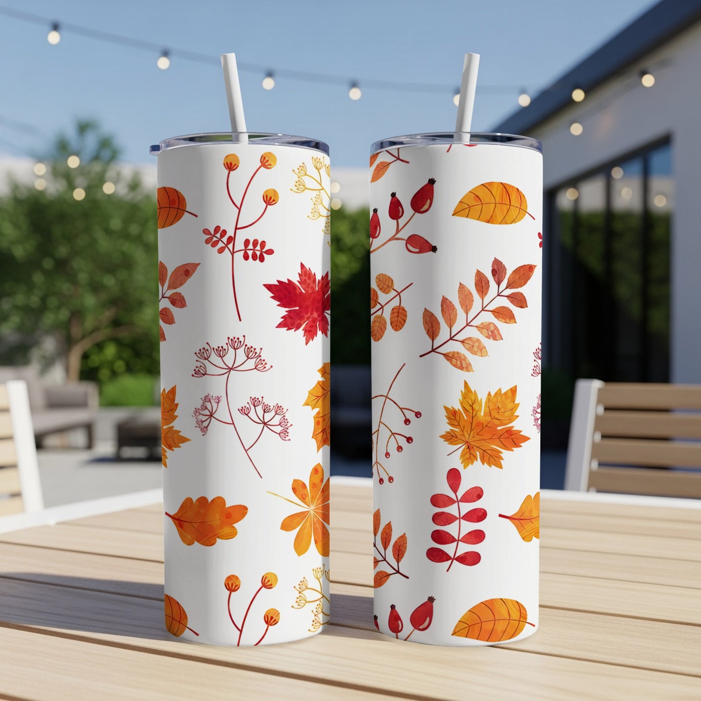Two white tumblers with an all-over pattern of autumn leaves and berries.