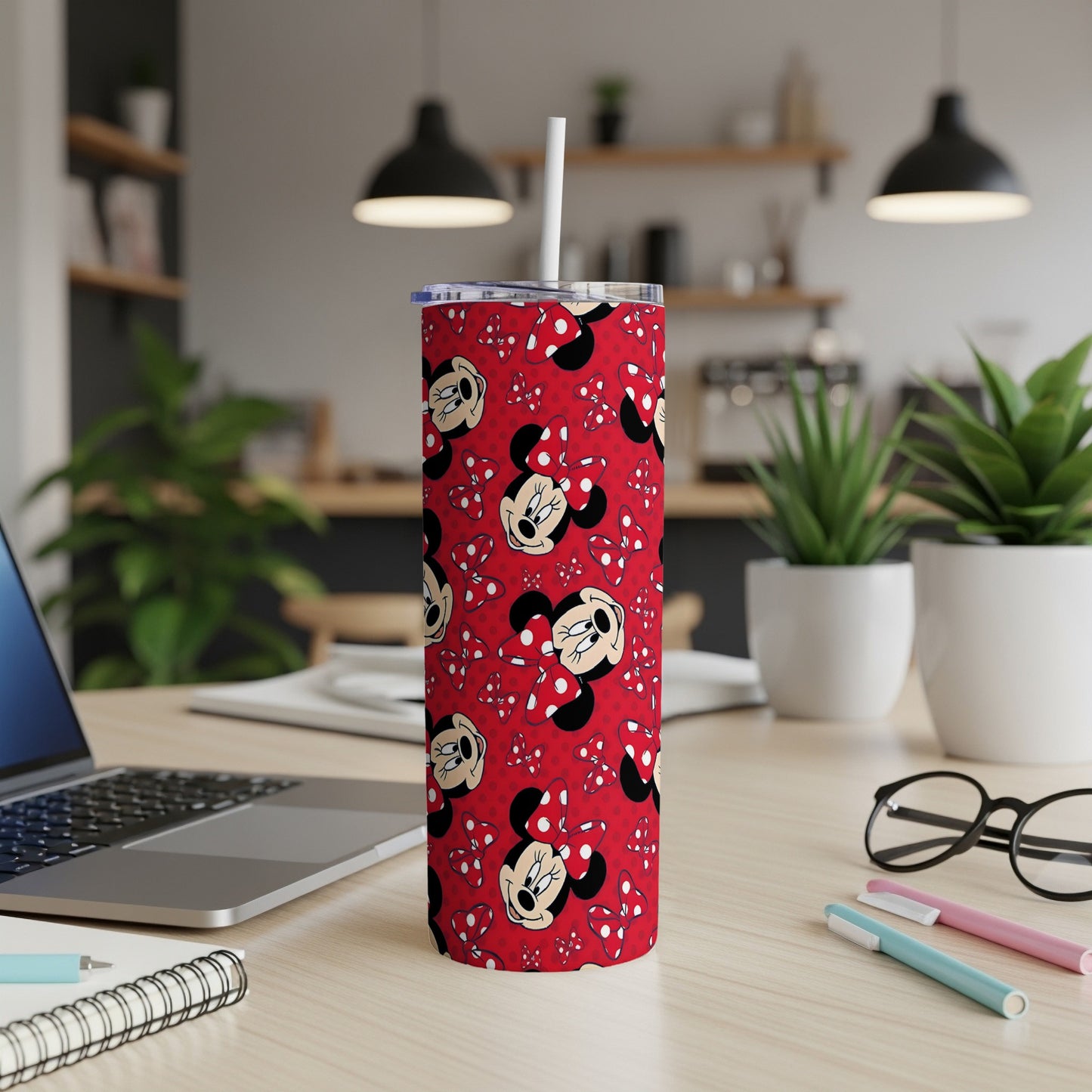 Red tumbler with Minnie Mouse pattern, white lid, and straw.