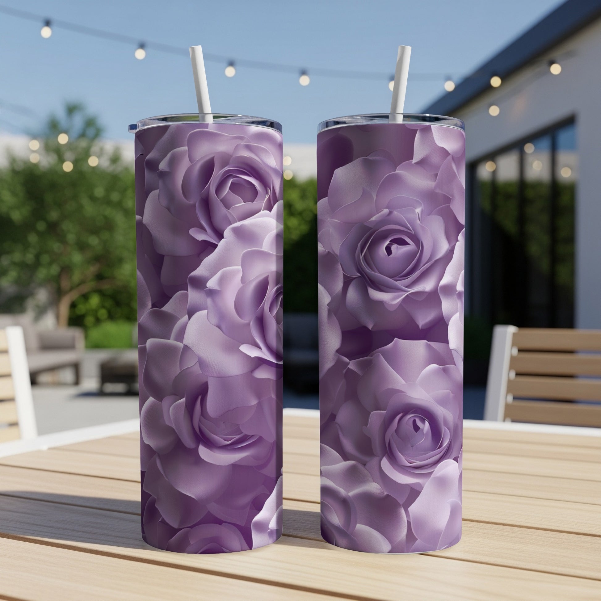 Two purple floral pattern tumblers on a wooden table with blurred outdoor background.