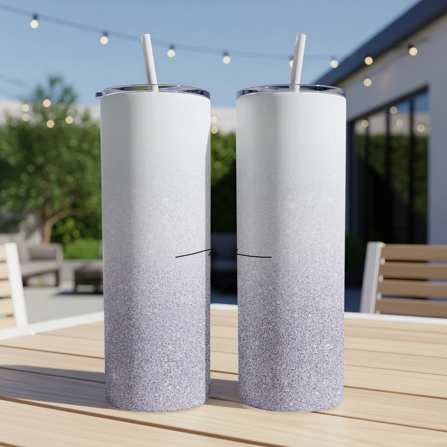 Two white tumblers with purple glitter ombre gradient design on a wooden table.