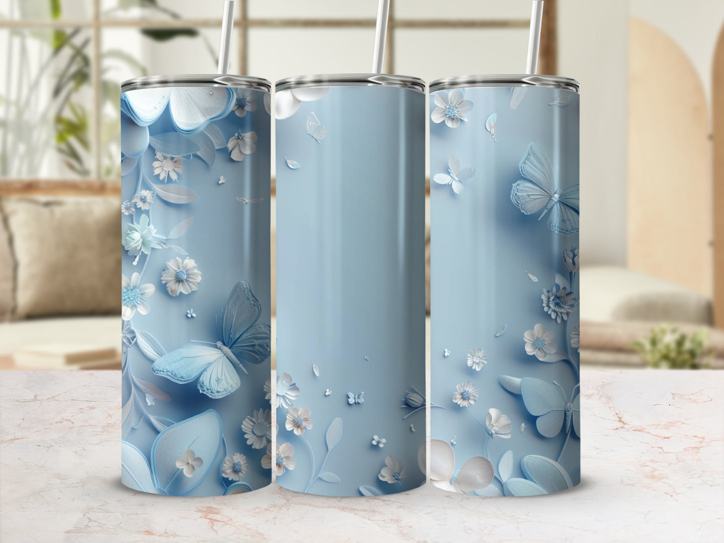 Three light blue tumblers with delicate floral and butterfly designs.