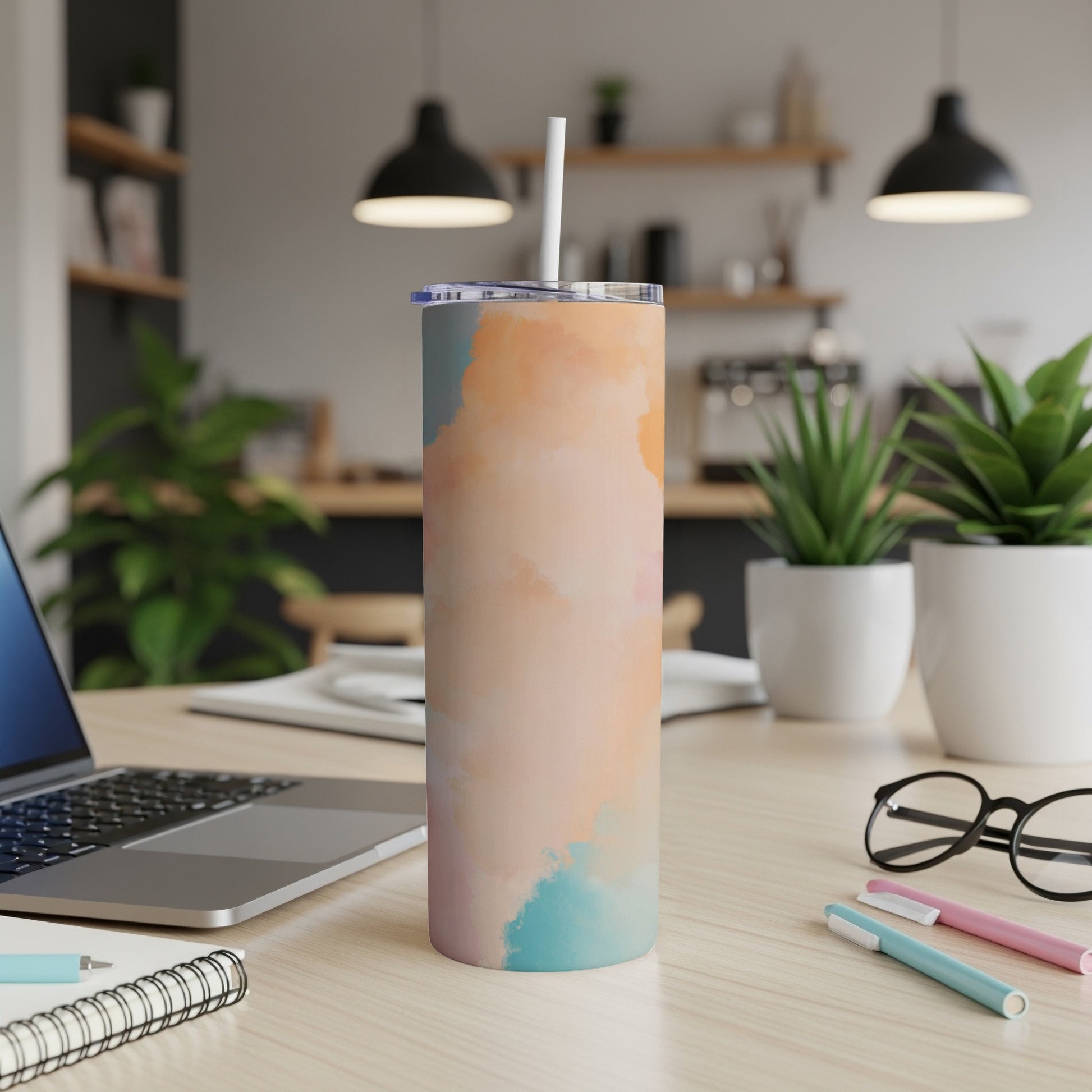 Tall tumbler with abstract watercolor design in peach, blue, and teal.