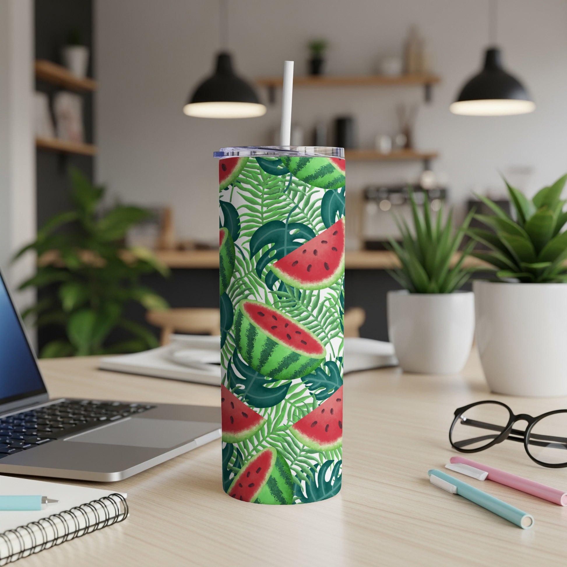 Watermelon and palm leaf pattern on a stainless steel tumbler with a straw.