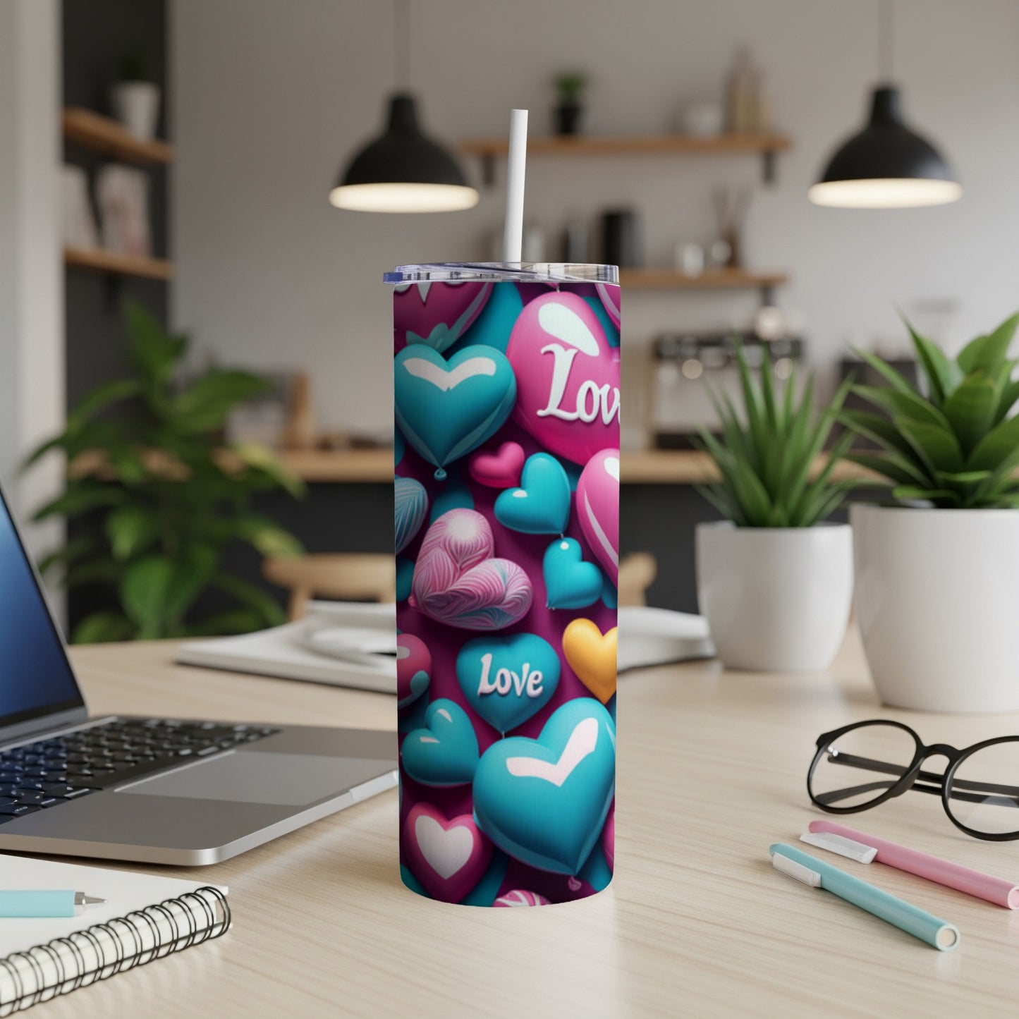 Tumbler with teal and pink heart designs and the word "Love".