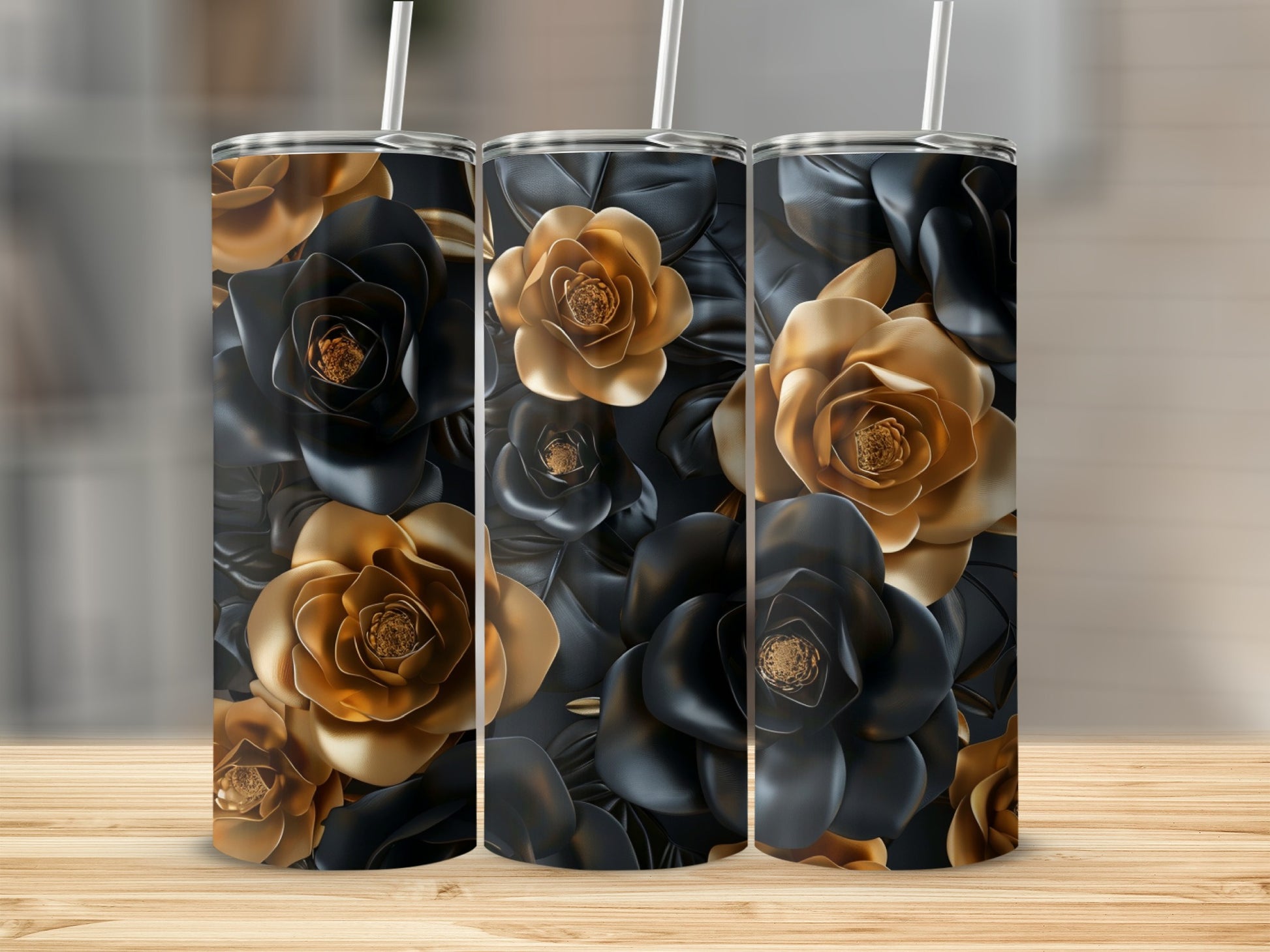 Three tumblers with black and gold floral patterns on a wooden surface.