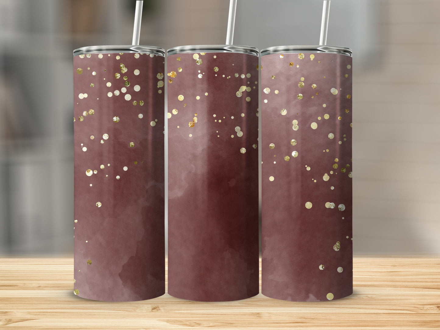 Three tumblers with a maroon watercolor design and scattered gold glitter.