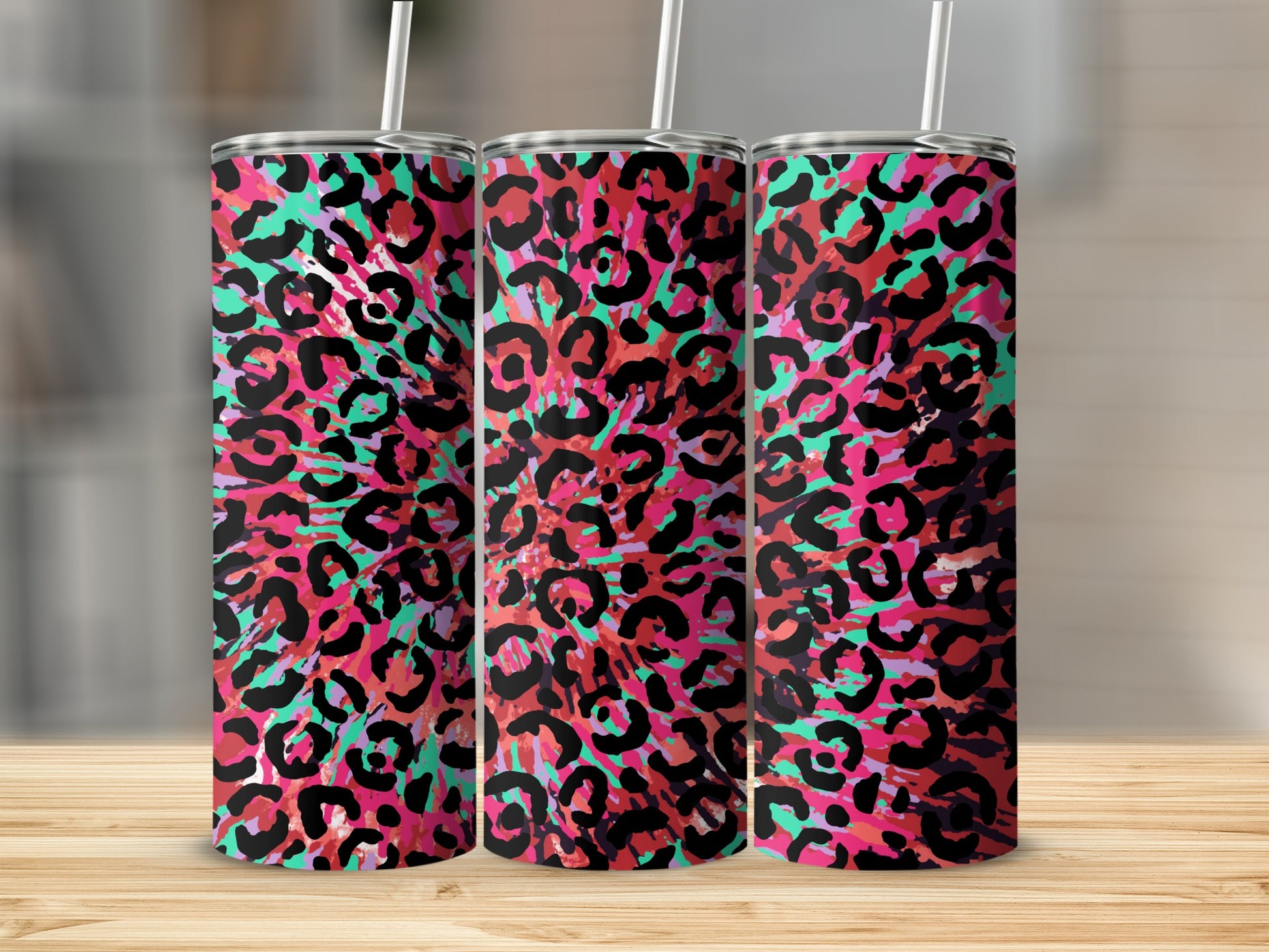Three tumblers with a vibrant pink, teal, and black leopard print pattern.