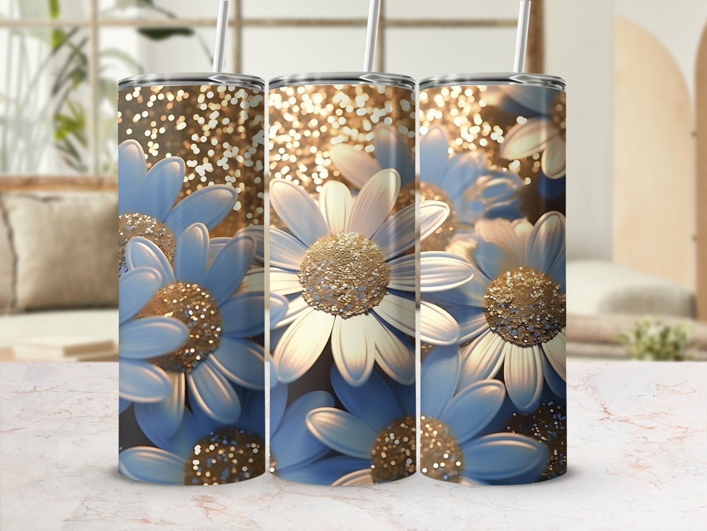 Three tumblers with blue daisies and gold glitter against a blurred background.